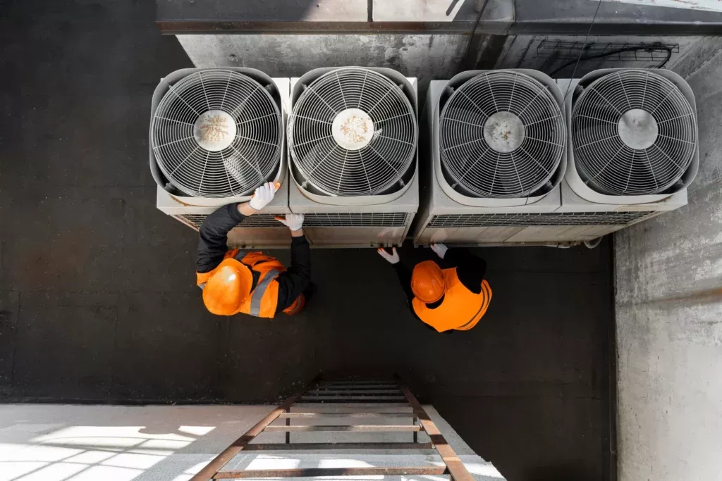 our extensive range of commercial hvac services and solutions, men working with equipment full shot scaled