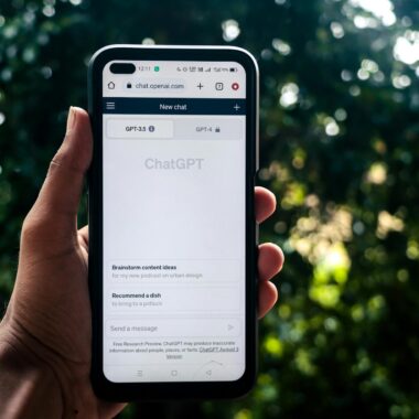 Webpage of ChatGPT, a prototype AI chatbot, is seen on the website of OpenAI, on a smartphone. Examples, capabilities, and limitations are shown.