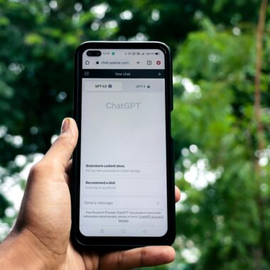 Webpage of ChatGPT, a prototype AI chatbot, is seen on the website of OpenAI, on a smartphone. Examples, capabilities, and limitations are shown.