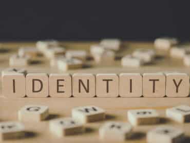 Blocs de bois épelant le mot « identité » après un changement de nom sur une table.