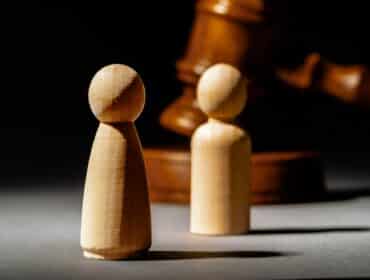 Wooden toy family and judge mallet. Family divorce concept