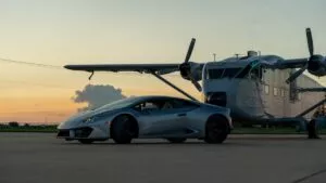 Image-6 shows a silver sports car parked on an airfield before a large propeller airplane at sunset, with a clear sky and distant clouds in the background.