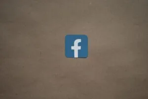 Image-4 displays a blue square featuring a white lowercase "f," symbolizing the Facebook logo, centered on a plain brown background.