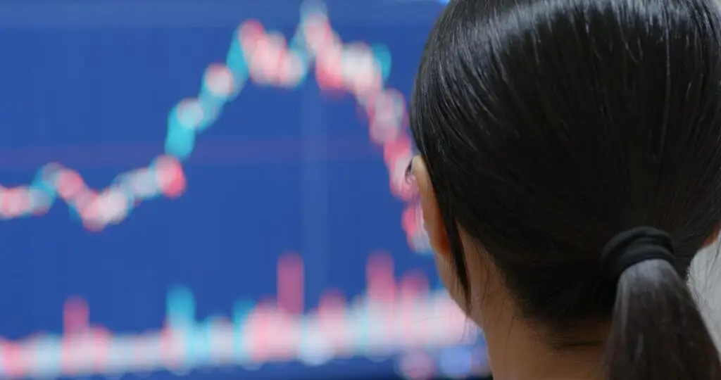 china woman watching the stock market graph s