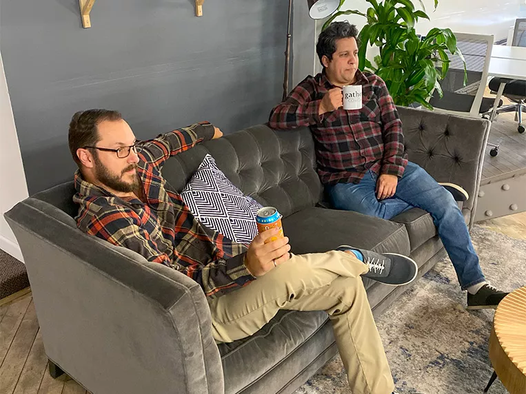 two men sitting down at lounge space at Coworking and Connect