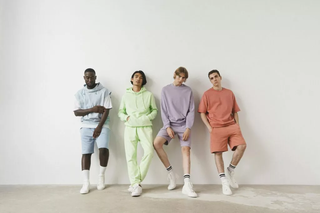 Four CozyVora models wearing pastel-colored comfy outfits standing against a white wall.