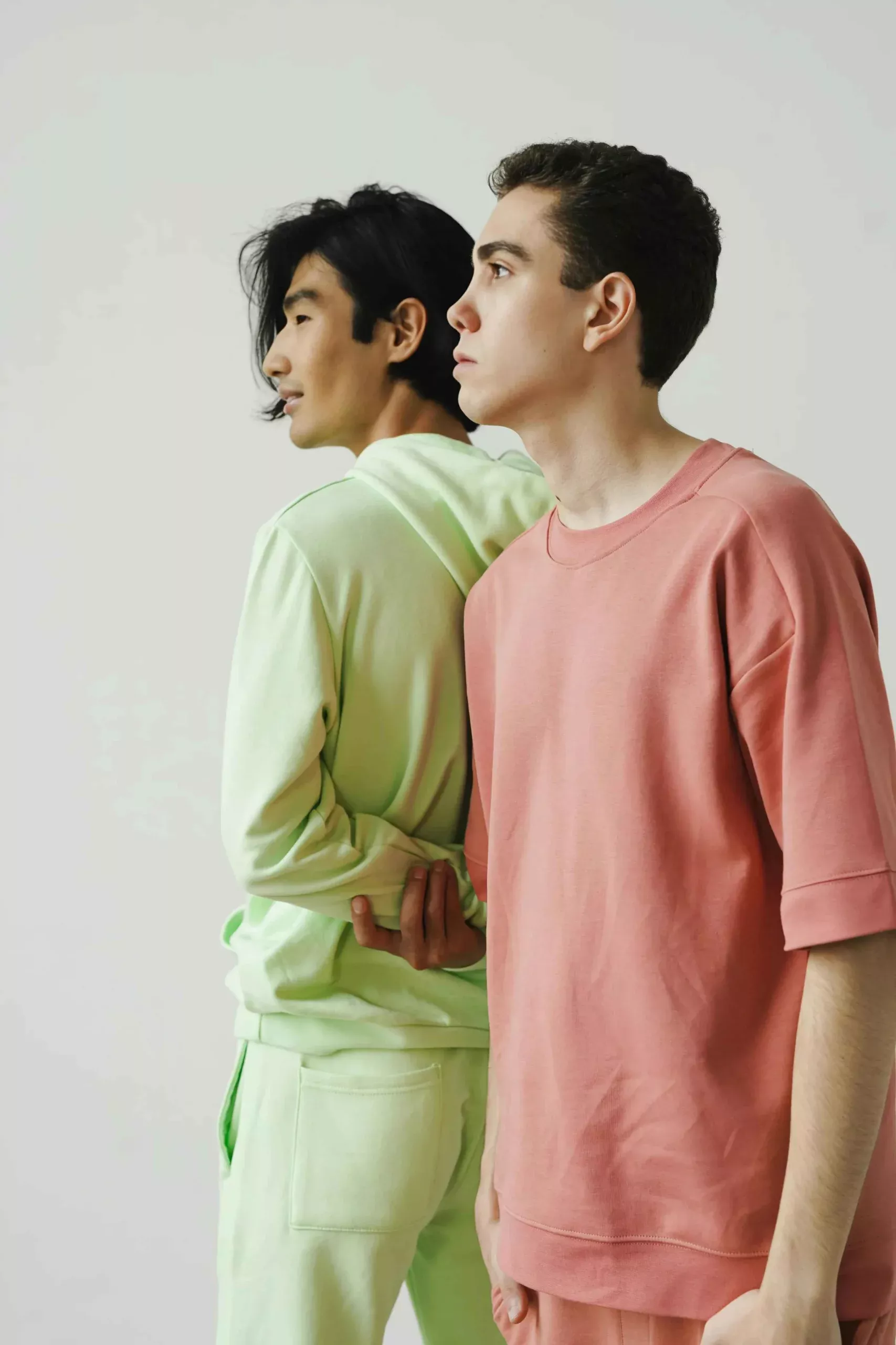 Two CozyVora models wearing pastel-colored outfits standing back-to-back against a plain background.