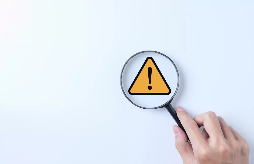image_Warning,Alert,System,Concept.,Magnifying,Glass,Focused,On,Yellow,Triangle
