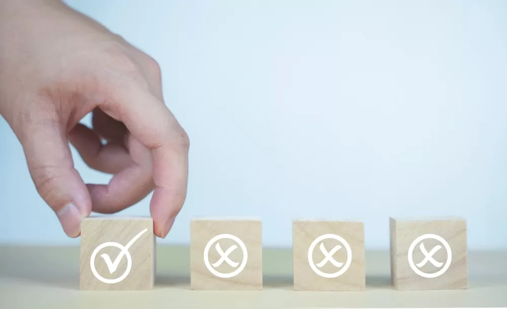image_A,Hand,Selects,A,Wooden,Cube,With,A,Check,Mark
