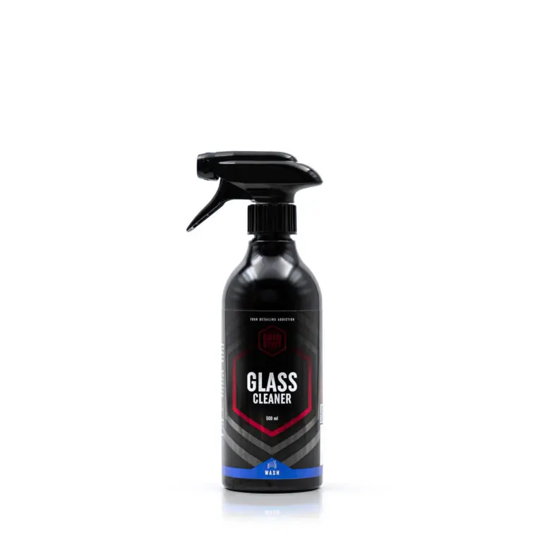 A black spray bottle labeled Glass Cleaner with a hexagonal design and blue accent, standing upright on a white background. This streak-free cleaner ensures spotless, gleaming surfaces every time.