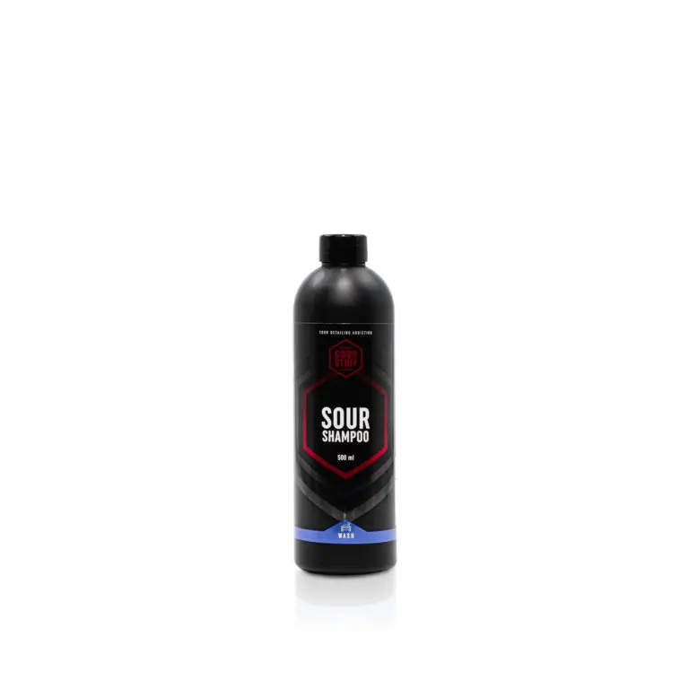 Eine schwarze Flasche "Sour Shampoo" mit roter und weißer Aufschrift und der Aufschrift "Lackschutz saures Autoshampoo" hat eine schwarze Kappe und einen blauen Akzent am unteren Rand vor einem schlichten weißen Hintergrund.