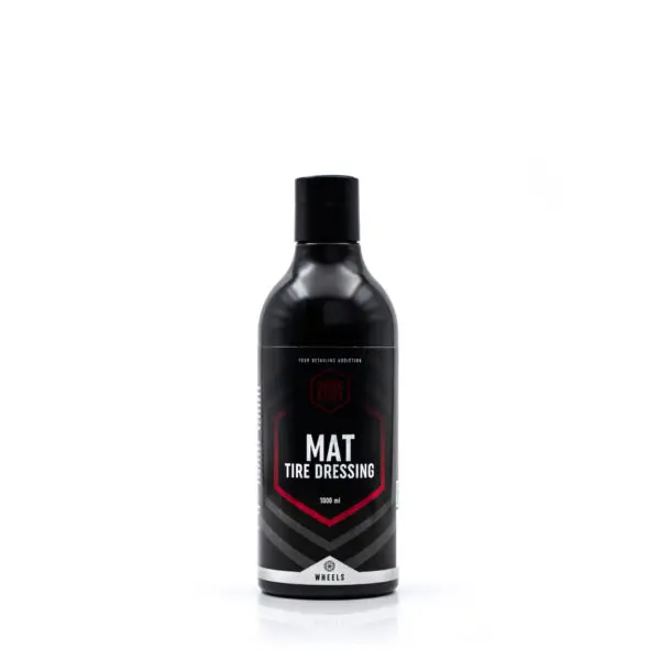 A black bottle of Mat Tire Dressing from Good Stuff with a black cap, featuring a modern label design in black, white, and red—perfect for wheel care—stands upright on a white background.