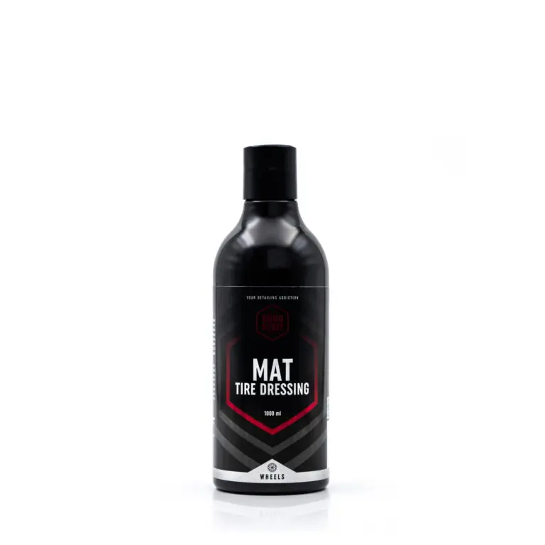 A black bottle of Good Stuff Mat Tire Dressing with a black cap, labeled Mat Tire Dressing 1000 ml in bold white and red text, stands upright against a plain white background—ideal for tire dressing and rubber protection.