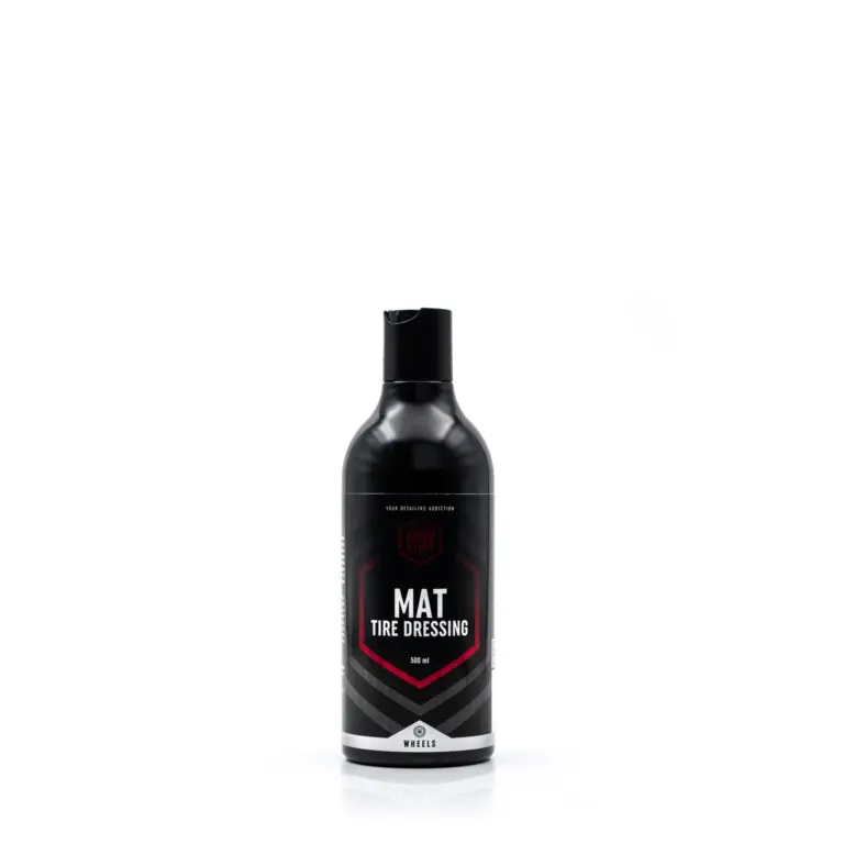 A black bottle of Good Stuff Mat Tire Dressing with a black cap stands upright against a plain white background. The label, featuring red, grey, and white accents, highlights its tire dressing formula for achieving a matte tire shine on wheels.