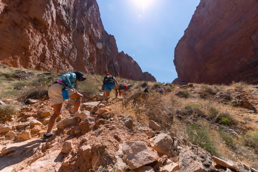 Side Hikes on a Grand Canyon River Trip: What You Need to Know 3 Hiking up a steep rough trail in the Grand Canyon