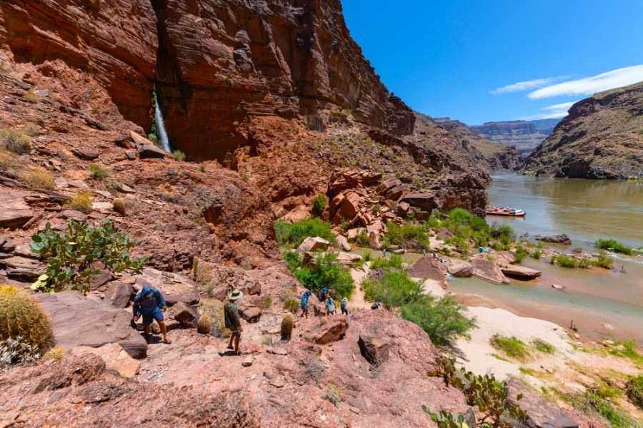 Side Hikes on a Grand Canyon River Trip: What You Need to Know 7 people hiking down to the Colorado River while on a motorized whitewater rafting trip