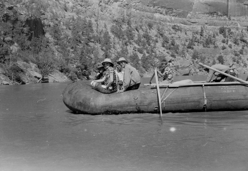 Surplus Pontoon 1950s 2 People in the 1950s riding a river rafting rig made of repurposed military surplus pontoons