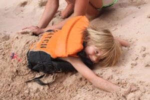 Top Tips for Whitewater Rafting with the Whole Family 1 Kid on Hatch trip plays in sand