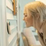 What Smart Home Devices Are Worth Buying? Smart thermostat mounted on wall in modern home