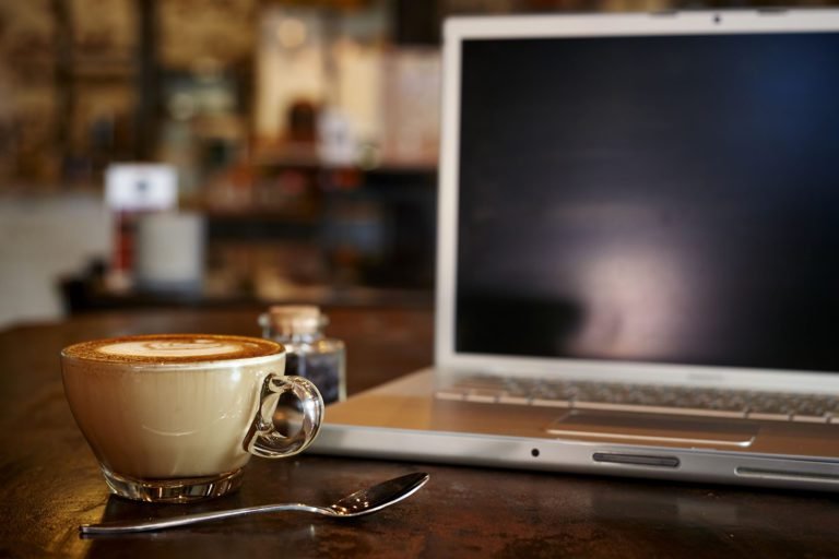a cup of coffee and a laptop