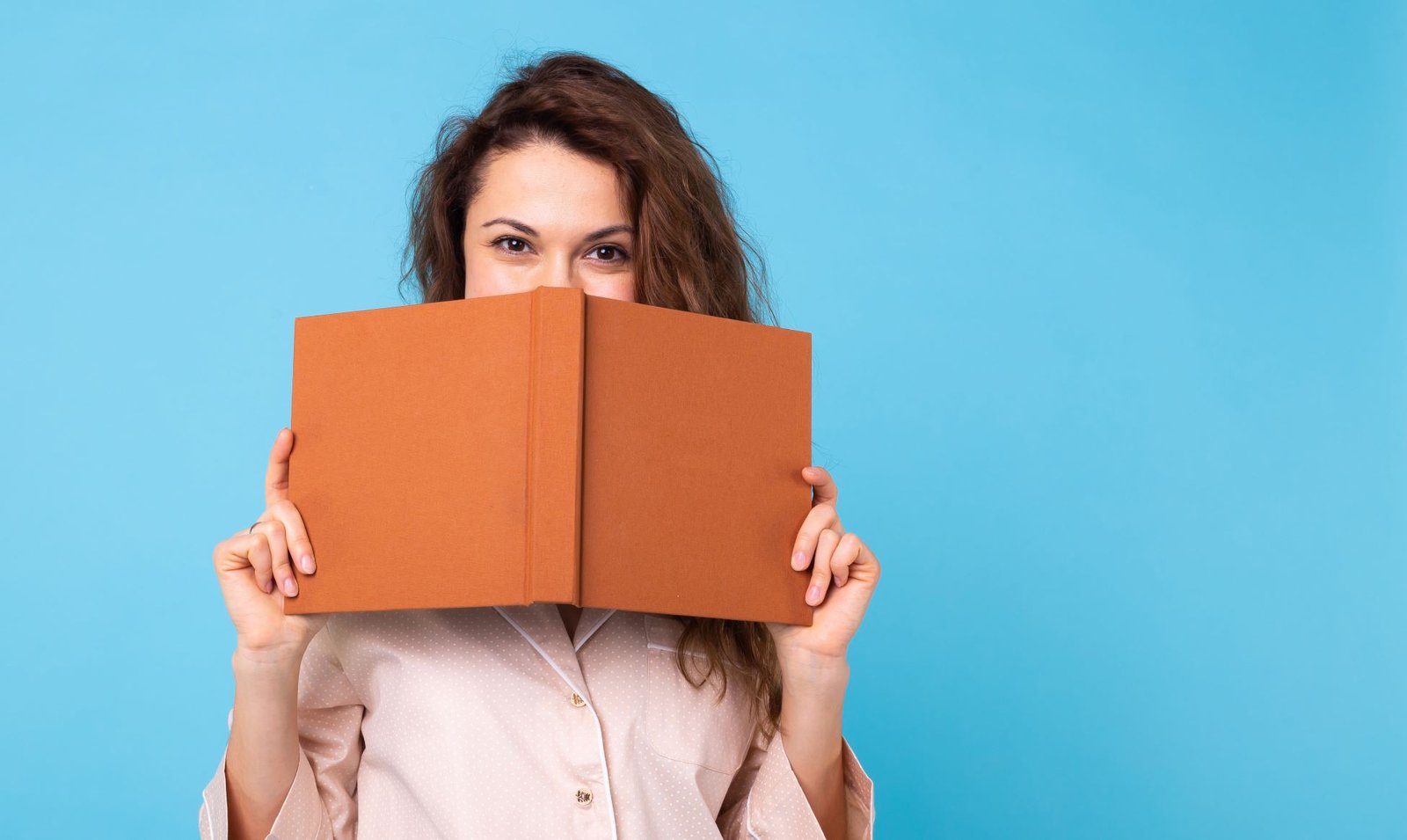 young girl is reading a book in pajamas on blue ba 2023 11 27 04 51 23 utc2opt