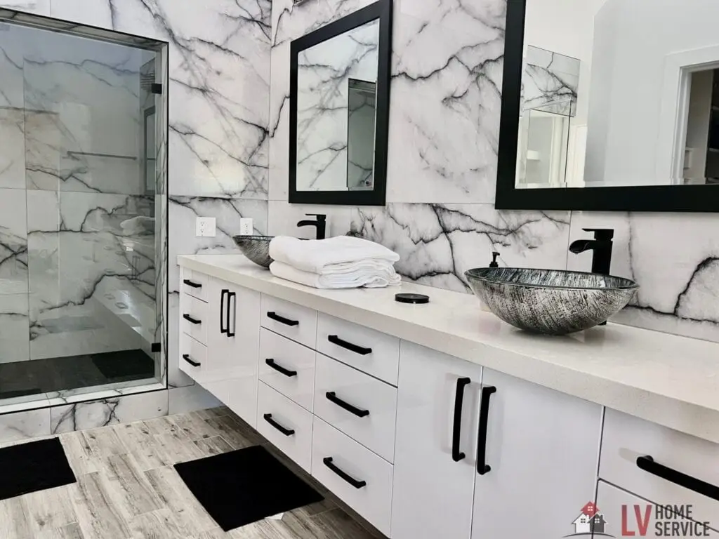 Luxury bathroom featuring a double sink vanity with black fixtures