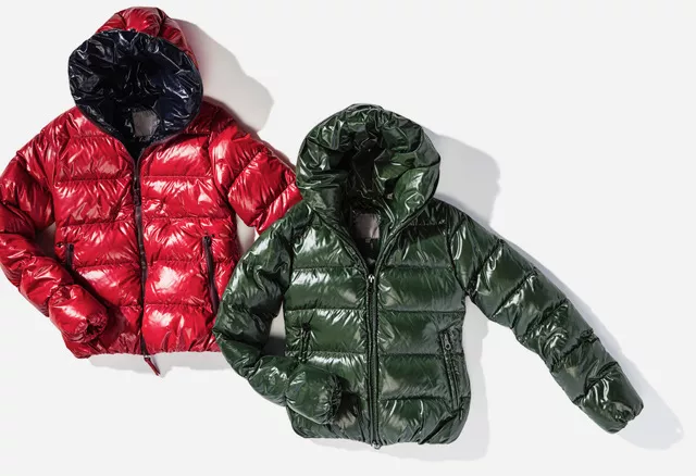 Two Glossy Puffer Jackets With Hoods, One Red And One Dark Green, Displayed Side By Side On A White Background, Embodying Couture Excellence. Perfect For Any Wardrobe Care Enthusiast Seeking To Blend Fashion With Functionality. Two Glossy Puffer Jackets With Hoods, One Red And One Dark Green, Displayed Side By Side On A White Background, Embodying Couture Excellence. Perfect For Any Wardrobe Care Enthusiast Seeking To Blend Fashion With Functionality.