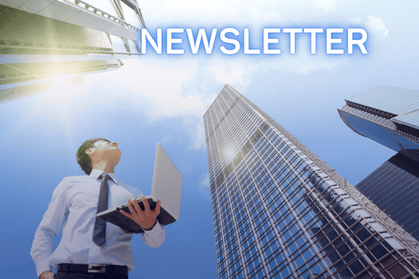 ビジネススーツを着た人が、明るい青空の下、高い高層ビルを見上げながらノートパソコンを持っており、その上部には「OESニュースレター」という文字が書かれています。