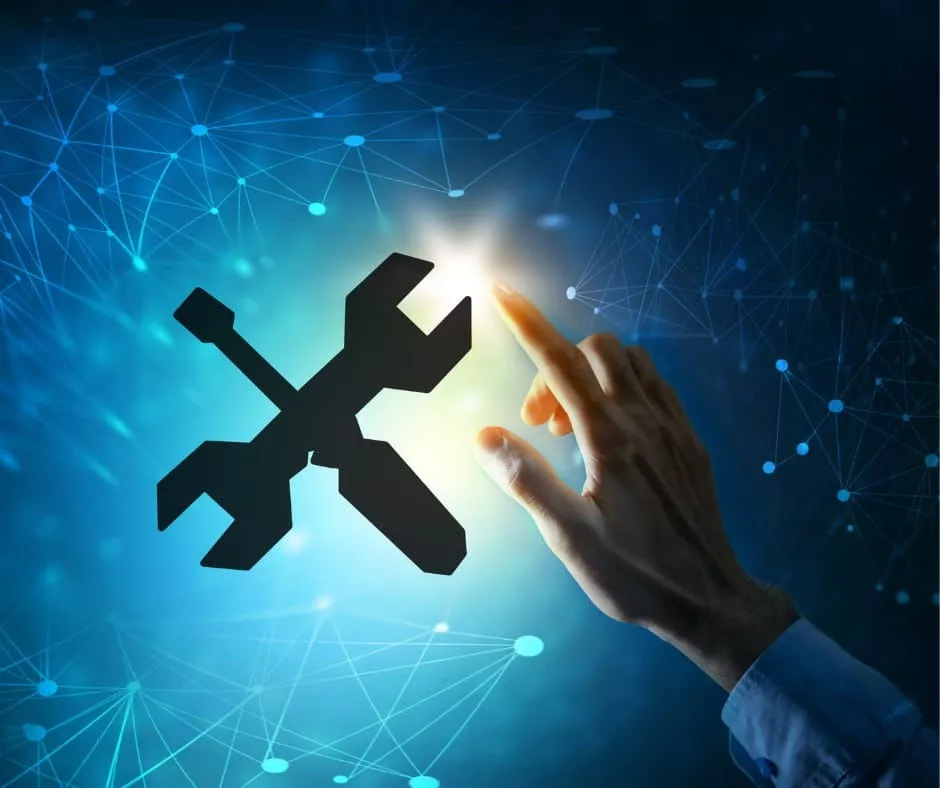 青い接続されたネットワークの背景に光るレンチとドライバーのアイコンに向かって手を伸ばし、Microsoft サポートとのシームレスな統合を象徴しています。.