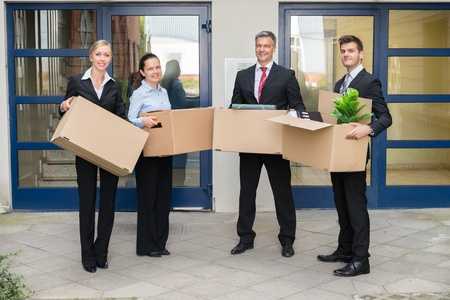 employees holding office moving boxes in Miami