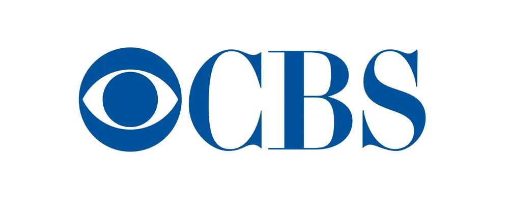 The CBS logo features a stylized blue eye symbol on the left, followed by the bold, uppercase blue letters "CBS" on a white background. The design is simple, clean, and iconic, representing the American television network.