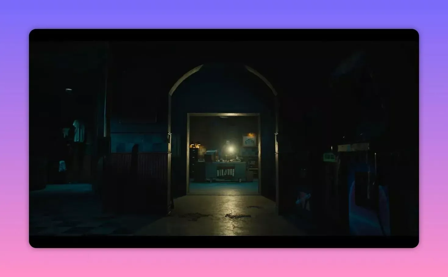 dim corridor framed by an archway leading to a lit security office desk