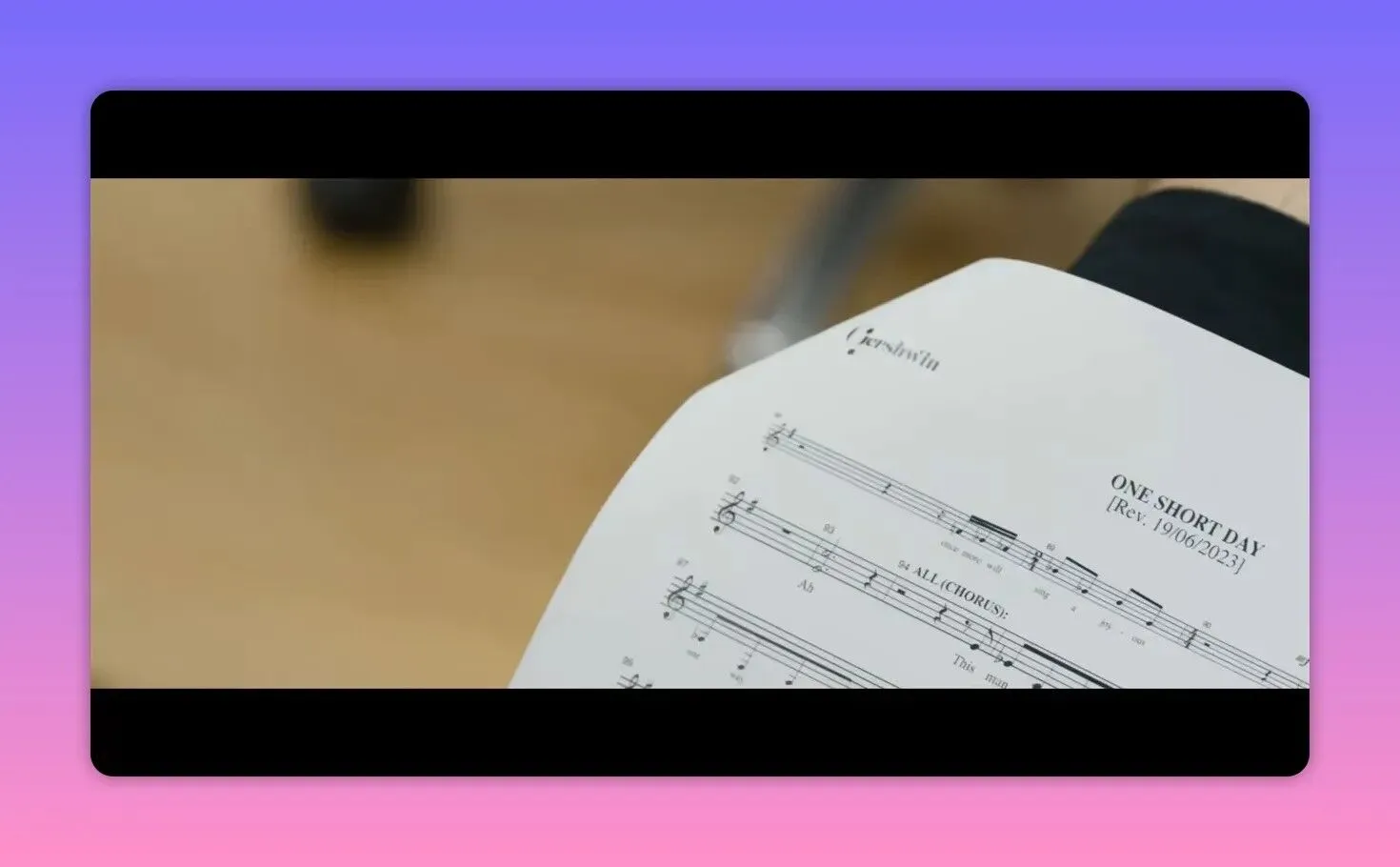 Close-up of printed sheet music titled 'ONE SHORT DAY' on a music stand