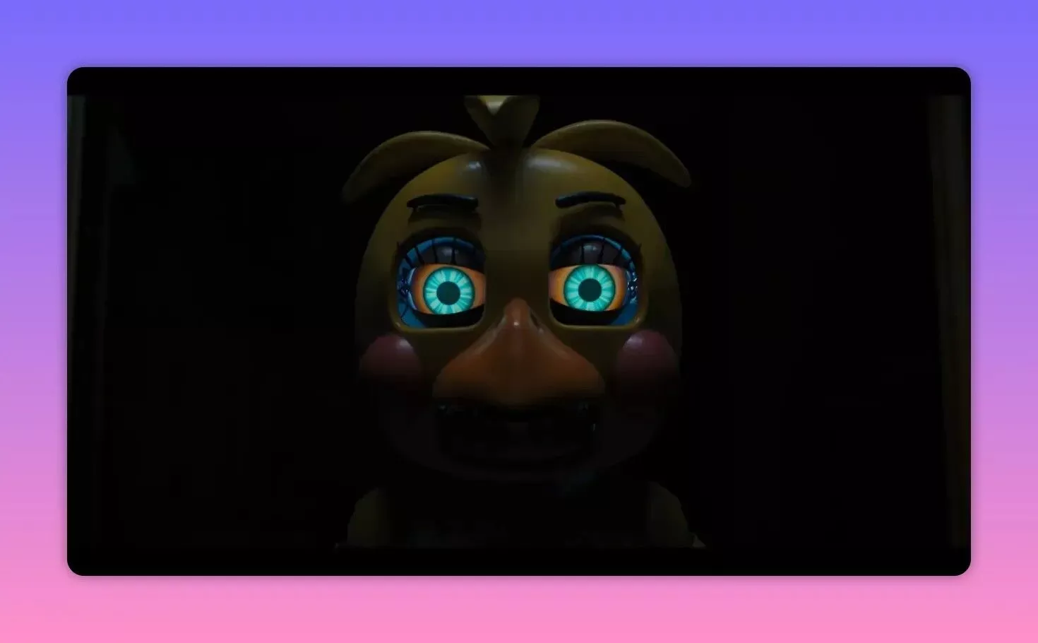 Front-facing animatronic face with bright mechanical eyes in a dark frame