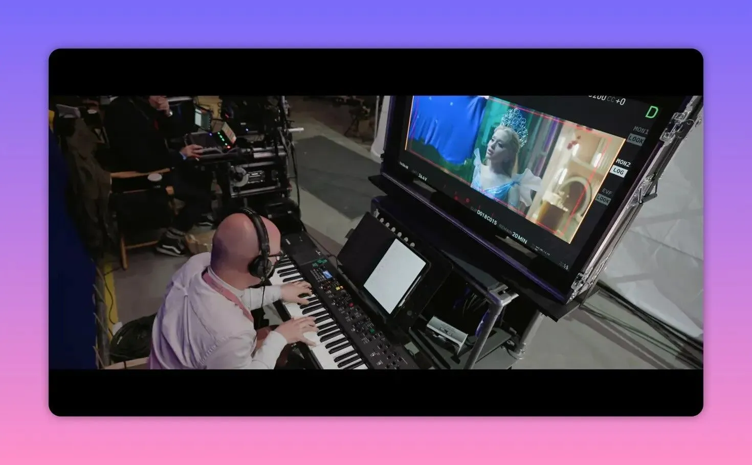 Keyboard player with headphones performing to a monitor showing the scene