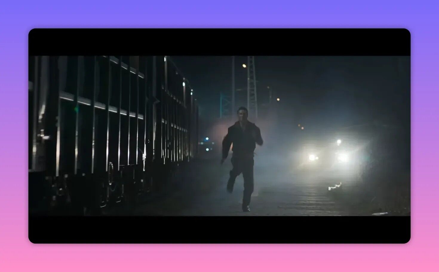 runner sprinting along a dark industrial rail yard at night with car headlights behind him