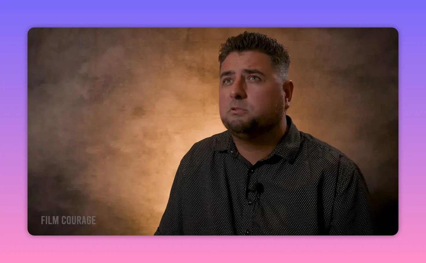 Clear studio interview portrait of the filmmaker discussing post-production and editing decisions that changed the film's structure.
