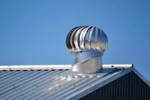 Attic ventilation system on a metal roof installed by our Buda roofers