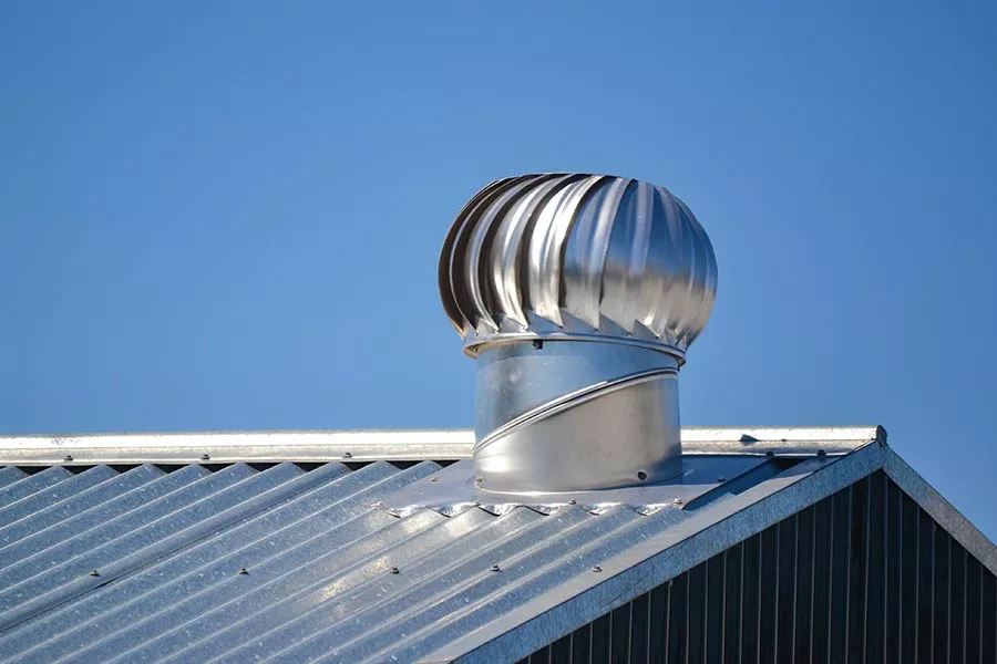 Attic ventilation system on a metal roof installed by our Buda roofers