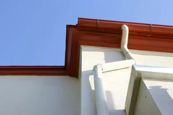 Photo of a downspout connected to a roof gutter