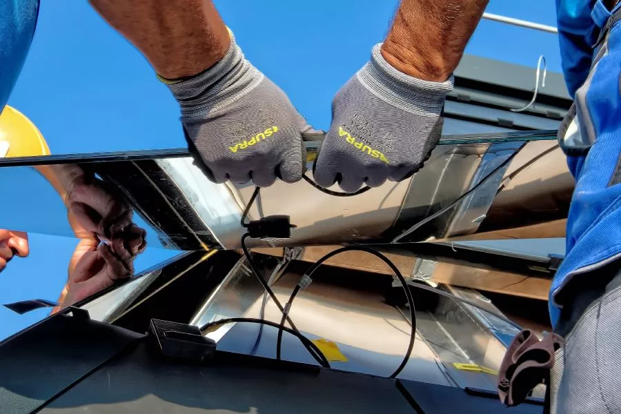 Close up of gloves performing a Professional New Braunfels TX solar roof Installation.