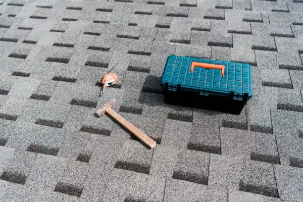 Toolbox and tools on a shingle roof