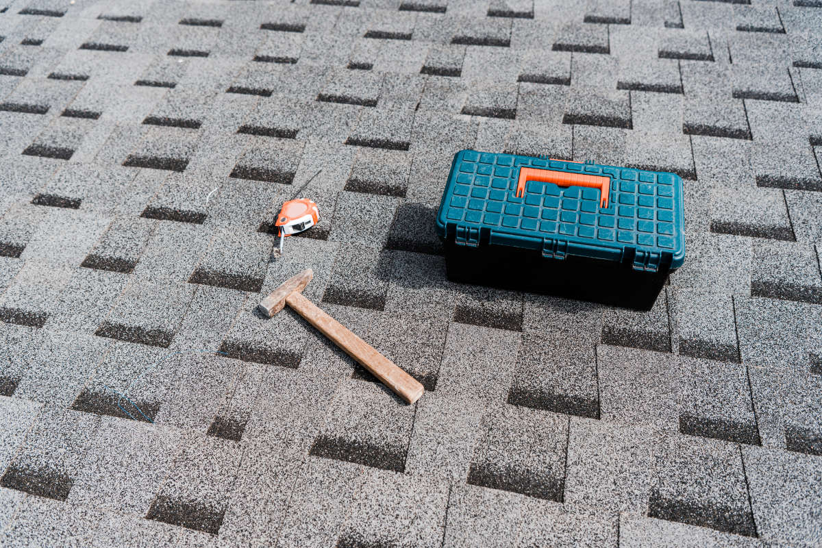 Toolbox and tools on a shingle roof