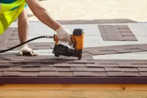 Professional Roofer installing asphalt shingles