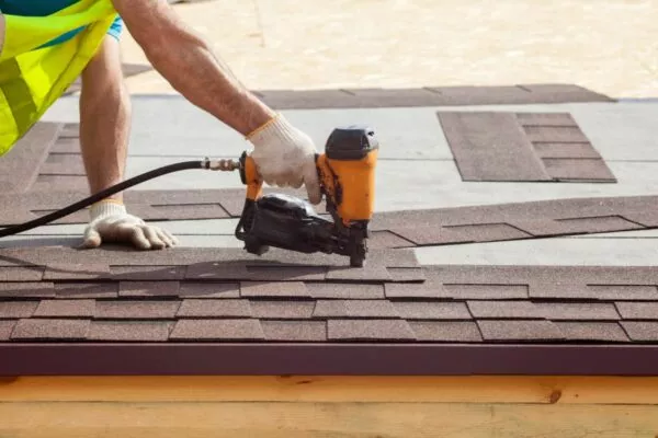 Professional Roofer installing asphalt shingles