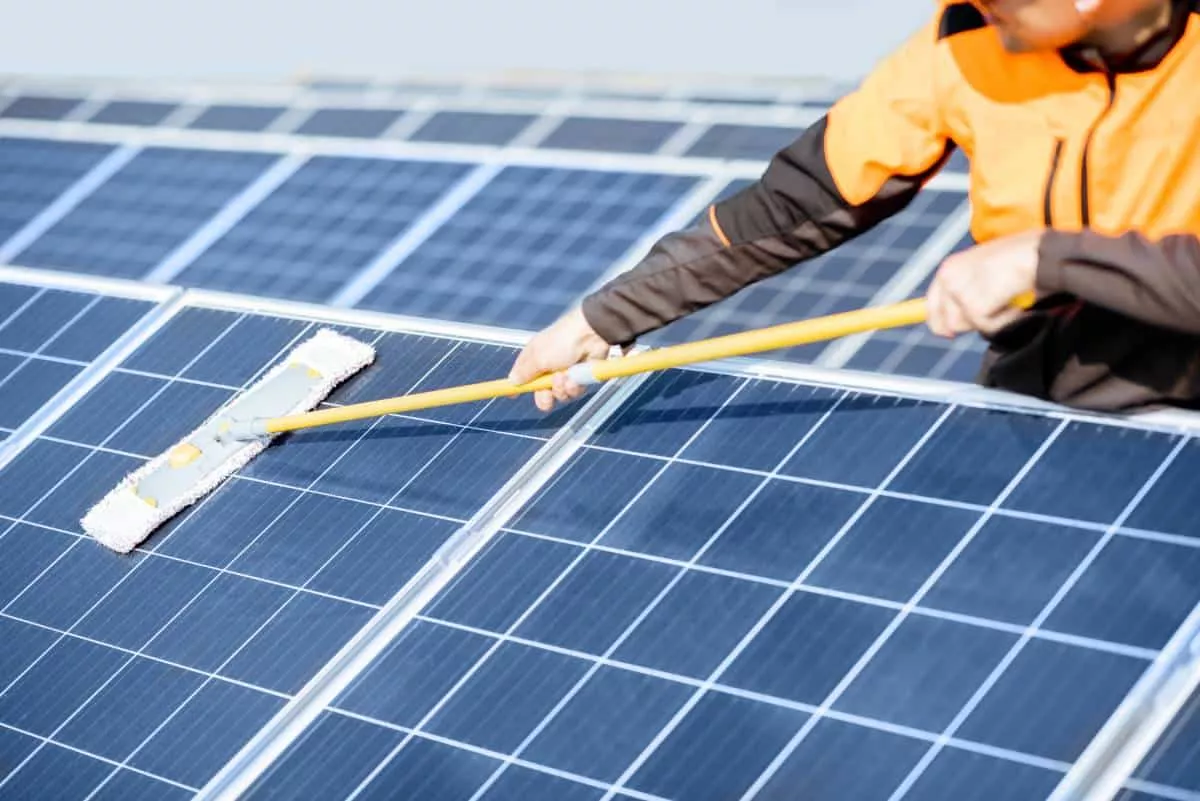 a man cleaning his Luling solar panels
