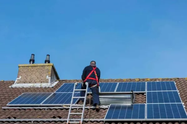 Austin Roofers installing solar panels on a residential roof.
