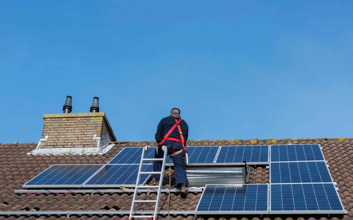 Austin Roofers installing solar panels on a residential roof.