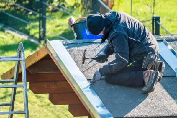man doing some storm damage roof repair in San Marcos