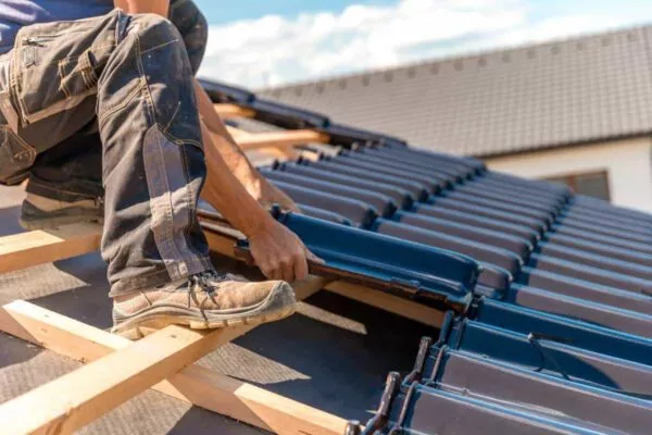 Close up of a man performing a roof installation in San Marcos TX.